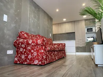 a red couch sitting in a living room at CASA DAS CEGONHAS in Faro