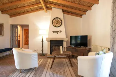 a living room with a fireplace and a tv at Quinta Molinum Ad Mare in Boliqueime