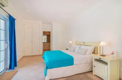 a bedroom with a large bed and a desk at Oceans 8. in Almancil