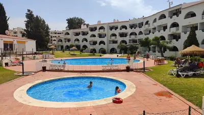a large swimming pool in front of a large building at Apartamento Centro de Albufeira Sunny in Albufeira