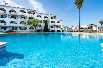 a large swimming pool in front of a building at Apartamento Centro de Albufeira Sunny in Albufeira