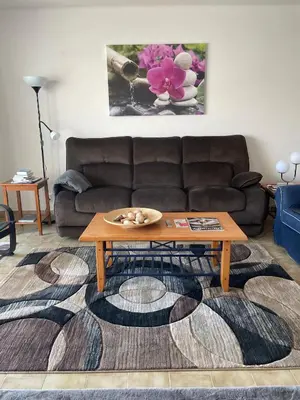 a living room with a couch and a coffee table at FeWo Cesar Manrique - Albufeira, Portugal in Albufeira