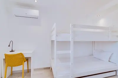 a bedroom with a white bunk bed and a desk at AL - Barracuda Village in Vilamoura