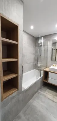 a bathroom with a shower and a tub and a sink at Beach View Vela House in Albufeira
