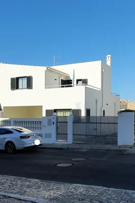 a car parked in front of a white building at Beach View Vela House in Albufeira