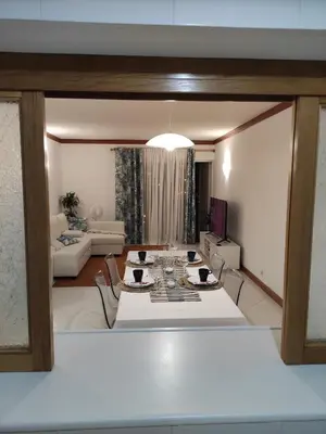 a living room with a table and a couch at Vilamoura Marina, Av Tivoli in Vilamoura