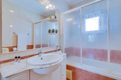 a white bathroom with a sink and a shower at AL - Colina Beach Holidays in Quarteira
