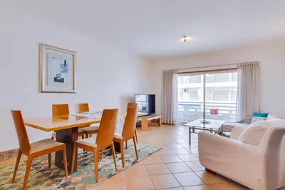 a living room with a table and a couch at AL - Colina Beach Holidays in Quarteira