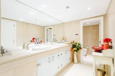 a bathroom with two sinks and a large mirror at Marina Real - Sea View by HD PROPERTIES in Vilamoura