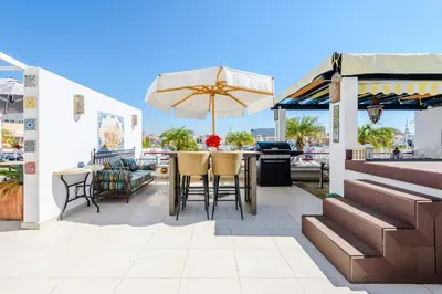 a patio with a table and chairs and an umbrella at Marina Real - Sea View by HD PROPERTIES in Vilamoura