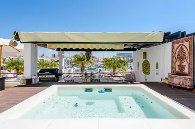 a swimming pool on a patio with a table at Marina Real - Sea View by HD PROPERTIES in Vilamoura