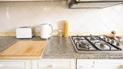 a kitchen counter top with a stove and a counter top at Villa Aldeia do Golf - BY BEDZY in Vilamoura