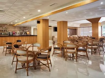 a restaurant with wooden chairs and tables and a bar at Albufeira Sol Villas I by Stay ici Algarve Holiday Rental in Albufeira