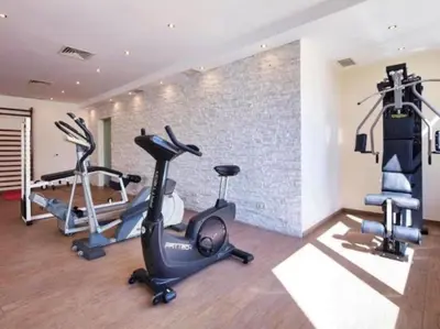 a gym with two treadmills and two exercise bikes at Albufeira Sol Villas I by Stay ici Algarve Holiday Rental in Albufeira