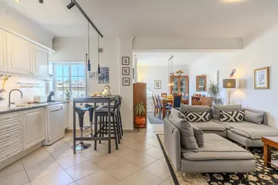 a kitchen and living room with a couch and a table at #056 Old Post Office by Home Holidays in Albufeira