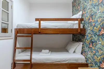 a table with cups and croissants and a tea kettle at #056 Old Post Office by Home Holidays in Albufeira