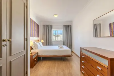 a bedroom with a bed with the words home holidays at #056 Old Post Office by Home Holidays in Albufeira