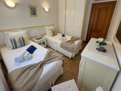 a hotel room with two beds with towels on them at Akisol Olhos de Água Ocean in Albufeira