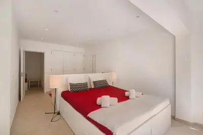a bedroom with a large bed with black and white pillows at Large apartment in Vale do Lobo in Almancil