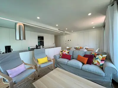 a living room with a blue couch and two chairs at Faro Design 1 by Homing in Faro