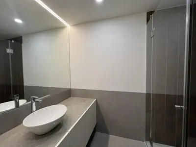 a bathroom with a white sink and a shower at Faro Design 3 by Homing in Faro