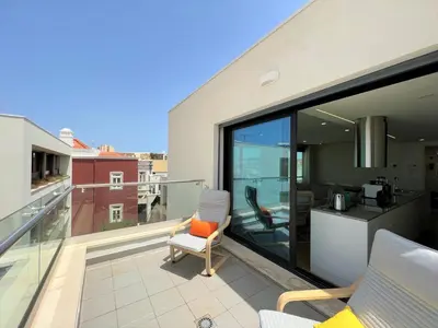 a balcony with a chair sitting on top of a building at Faro Design 3 by Homing in Faro