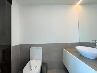 a bathroom with a white sink and a toilet at Faro Design 2 by Homing in Faro