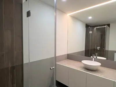 a bathroom with a sink and a glass shower at Faro Design 2 by Homing in Faro