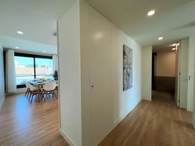 an empty living room with a table and chairs at Faro Design 2 by Homing in Faro