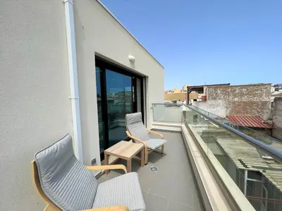 a balcony with two chairs and a table on a building at Faro Design 2 by Homing in Faro