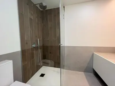 a bathroom with a glass shower with a toilet at Faro Design 2 by Homing in Faro