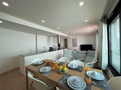 a dining room and kitchen with a table and chairs at Faro Design 4 by Homing in Faro