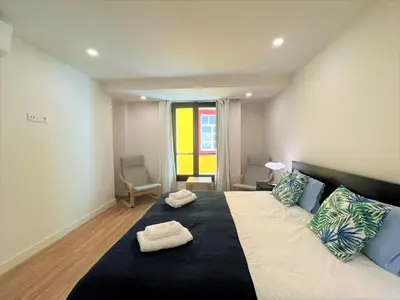 a bedroom with a large bed with two towels on it at Faro Design 4 by Homing in Faro