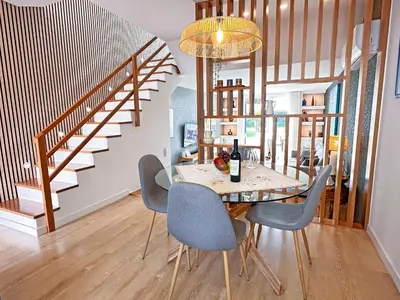 a kitchen with a glass table with a bottle of wine at Luxury Albufeira Townhouse with Terraces, Pool & Views by Be Cherish in Albufeira