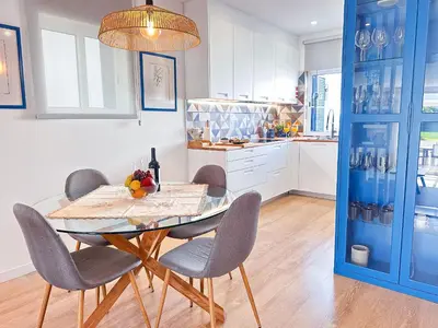 a living room with a chair and a television at Luxury Albufeira Townhouse with Terraces, Pool & Views by Be Cherish in Albufeira