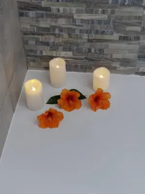 a group of candles and flowers on a table at Sun&Sea in Quarteira
