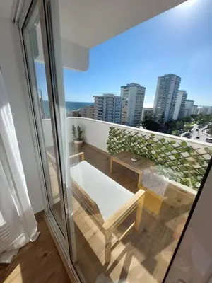a balcony with a bench and a view of the city at Sun&Sea in Quarteira