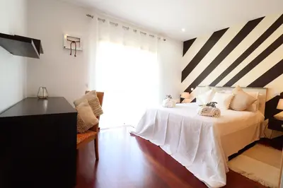 a bedroom with a bed with a striped ceiling at 3-Bed Townhouse with pool in Albufeira Balaia in Albufeira