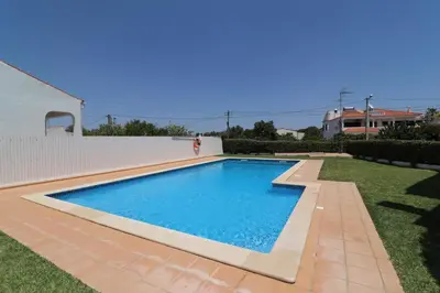 a swimming pool in the backyard of a house at 3-Bed Townhouse with pool in Albufeira Balaia in Albufeira