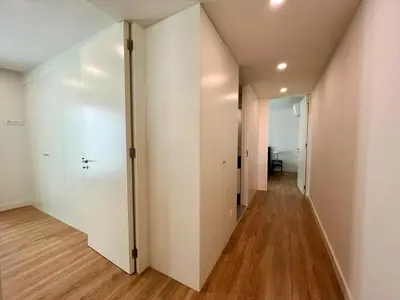 a hallway of an apartment with white walls and wooden floors at Faro Design 6 by Homing in Faro