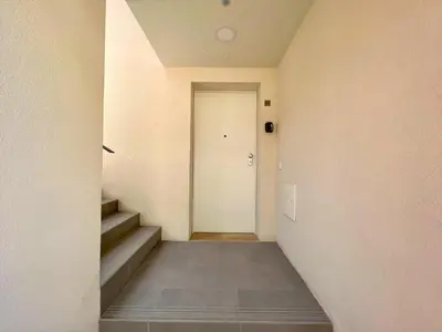 a hallway with a white door and stairs at Faro Design 6 by Homing in Faro