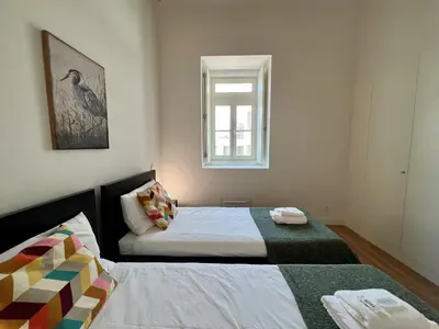 a bedroom with two beds and a window at Faro Design 7 by Homing in Faro