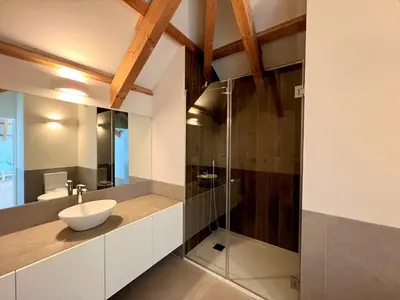 a bathroom with a sink and a glass shower at Faro Design 7 by Homing in Faro