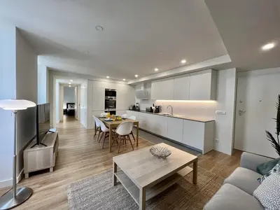 a kitchen and a living room with a table and chairs at Faro Design 7 by Homing in Faro
