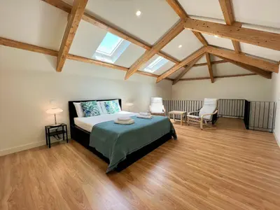 a bedroom with a bed and two chairs in it at Faro Design 7 by Homing in Faro
