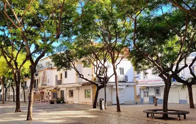 a room with two chairs and a table and two windows at In Downtown - Villa Serenity in Albufeira