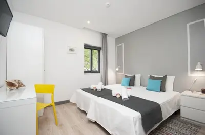 a kitchen with a white island and a dining room at In Downtown - Villa Serenity in Albufeira