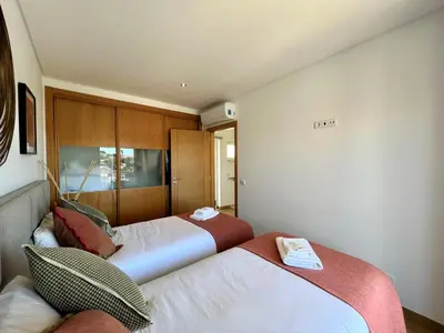 a bedroom with two beds at Albufeira Deluxe Residence With Pool by Homing in Albufeira