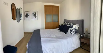 a bedroom with a large bed with white sheets and pillows at Albufeira Deluxe Residence With Pool by Homing in Albufeira