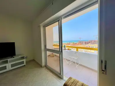 a living room with a view of the ocean at Quarteira Panoramic View by Homing in Quarteira
